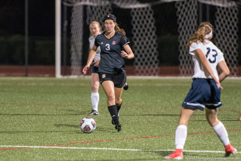 Emily Maxwell during a game at Lynchburg, running, with defender in foreground