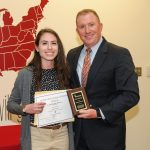 Melissa Bauerle receives scholarship certificate from Josh Bailey