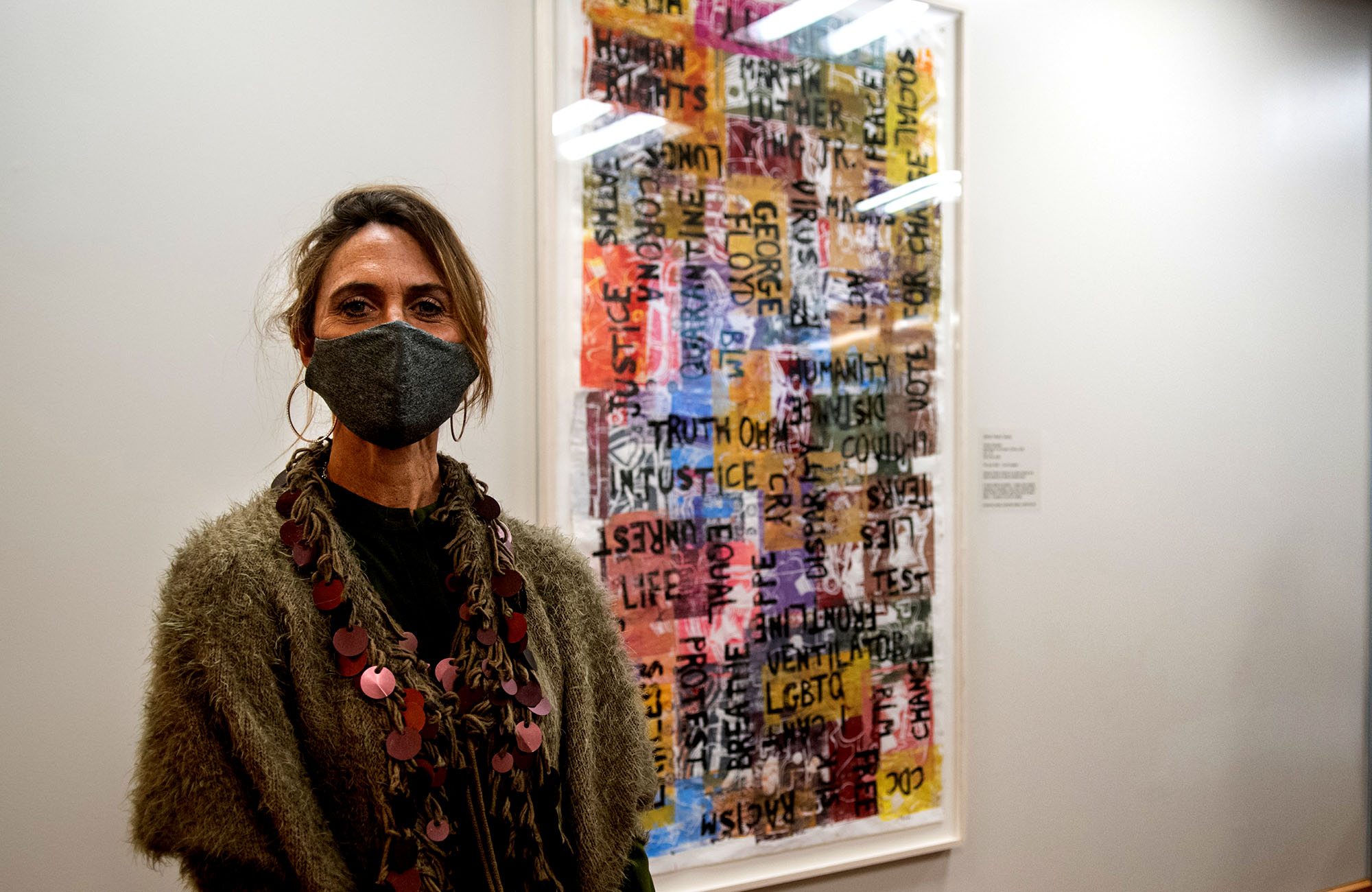 Artist Frankie Slaughter stands beside her artwork spring 2020