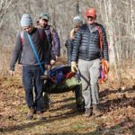 Wilderness First Aid class participants practice carrying an injured person.