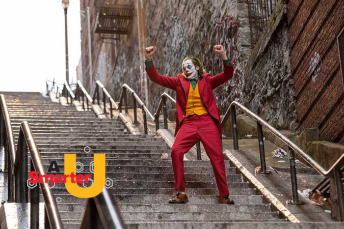 Image from the Joker movie showing the joker dancing down concrete steps. The logo for A Smarter U shows in the foreground