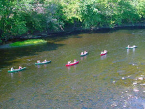 Six canoes float down the James River.