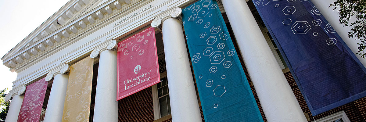 Hopwood Hall with colorful banners that are hanging between the columns