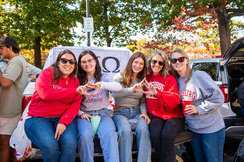 A group of female alumni tailgating at Homecoming
