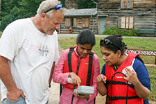 Dr. Tom Shahady and two graduate students investigating water quality