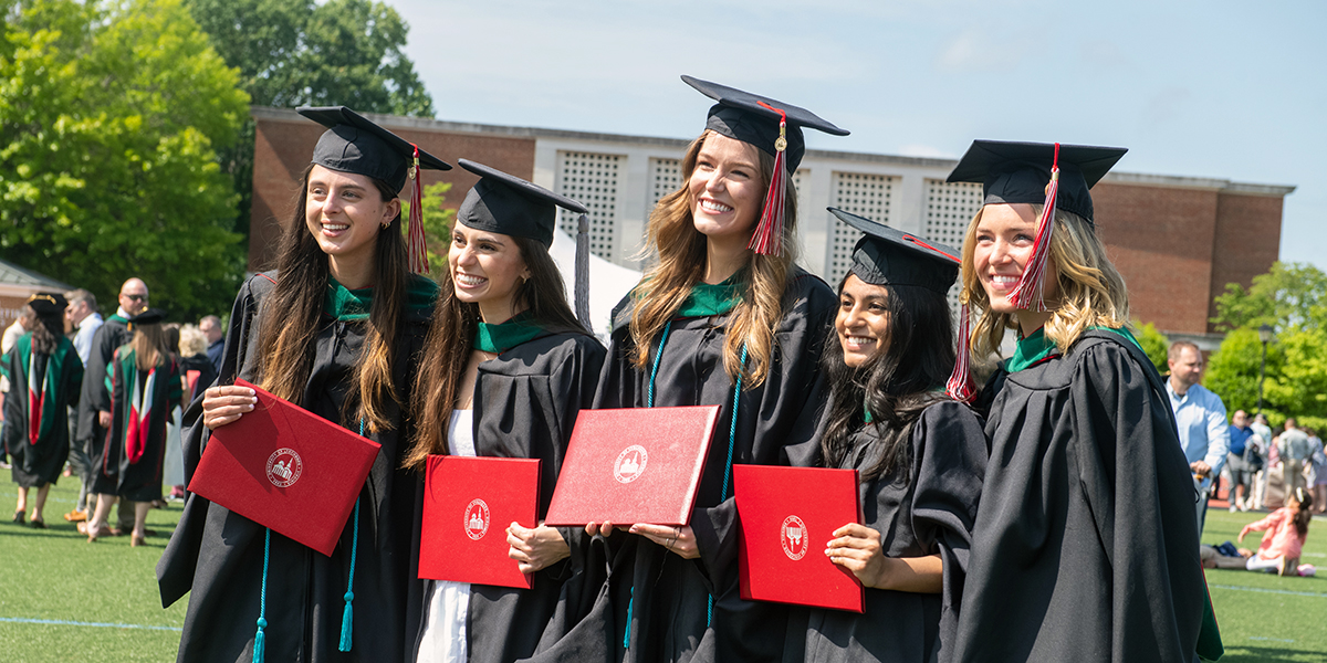 A group of female graduates pose for a photo during commencement