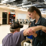 DPT student working on the shoulder of a patient in the University of Lynchburg Community Health Clinic