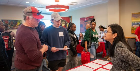 Professor Ei Hlaing talks with a parent and his son at Discovery Weekend