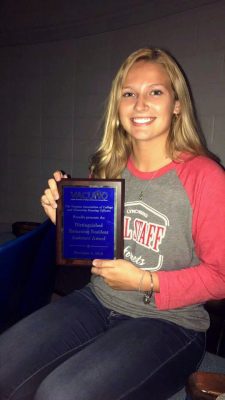 Gabby Jones holding plaque recognizing her award win