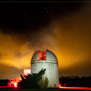 Belk Observatory at night with an orange sky thumbnail