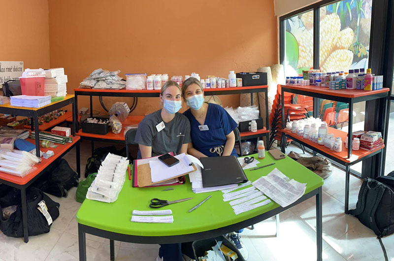 Two people in an office surrounded by medical equipment.