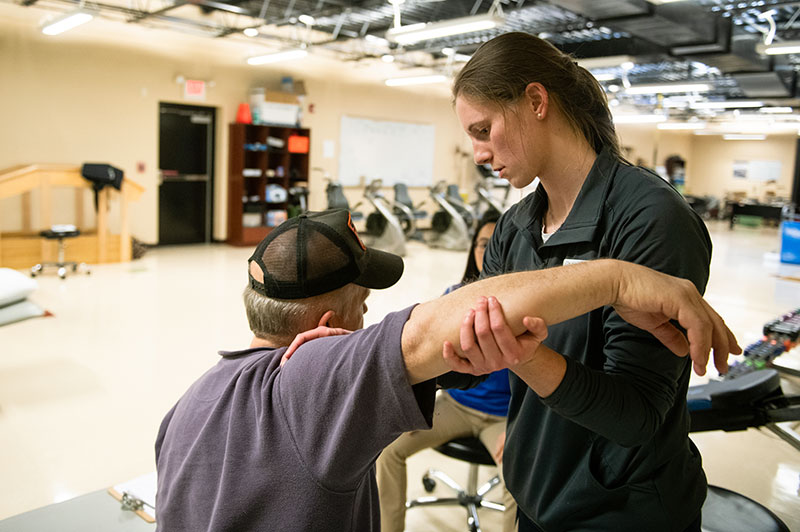 A Doctor of Physical Therapy student works with a patient