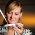 Alyson Black is using a pipette while conducting research