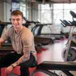 Eric Oehler in the fitness center, surrounded by equipment