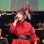 Sloan Kelly singing during a Christmas production