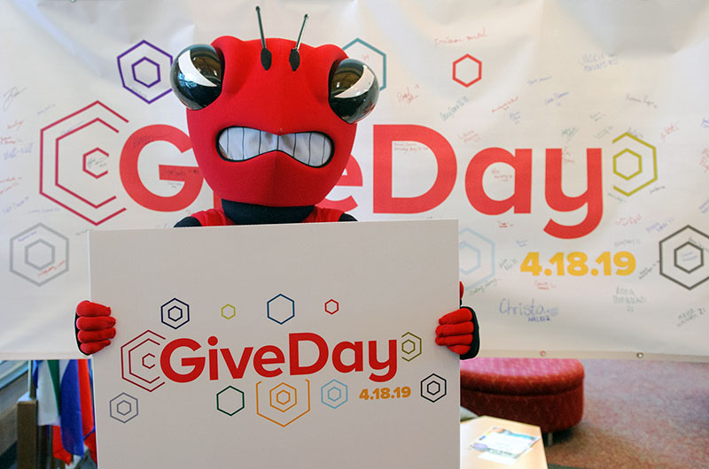 The Hornet holding  a GiveDay sign