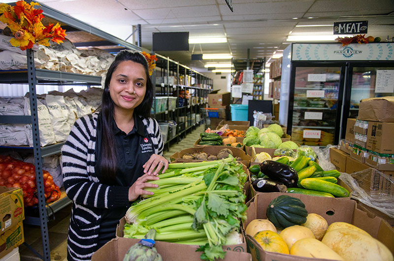 A Master of Public Health student working in a food pantry
