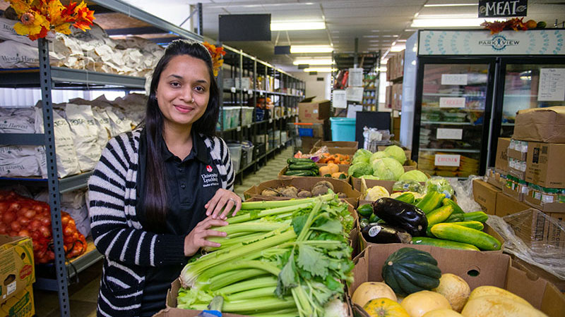 A Master of Public Health student working in a food pantry