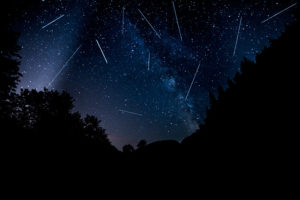 Meteor shower in night sky.