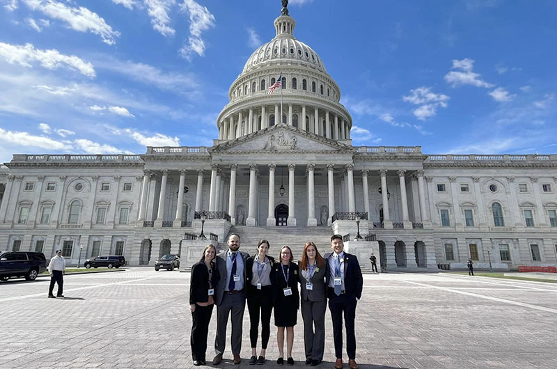 Six representatives from the University of Lynchburg stand in front to the Capitol Building in Washington, D.C.