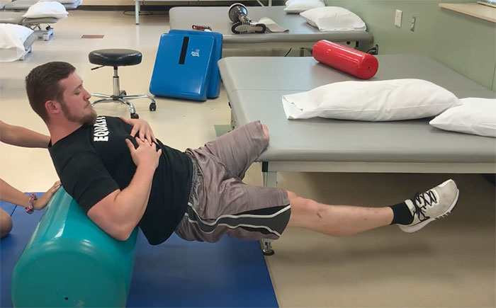 Patient performing advanced bridge exercise