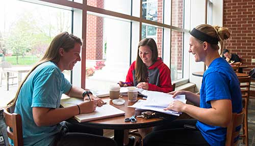 Group of three students studying