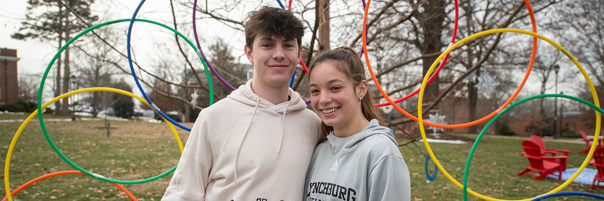 Two students standing in front of an art installation outdoors during the WonderHive winter festival