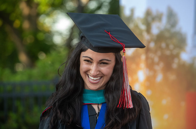 A female University of Lynchburg graduate in her regalia