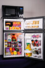 An open microfridge filled with food and drinks